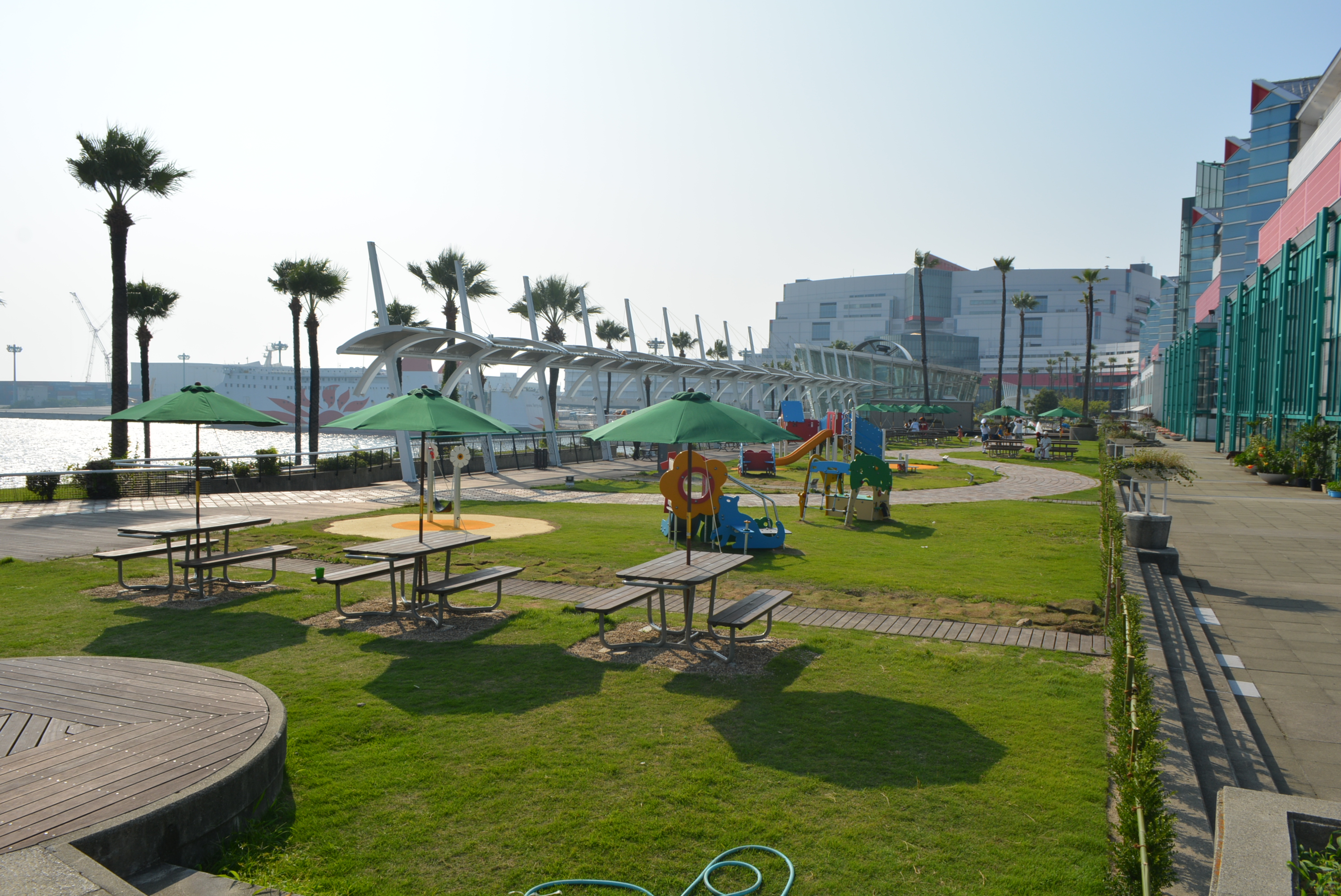 Visitors relaxing at ATC waterfront park with scenic Osaka Bay views and walking paths